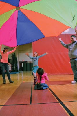 Strengthening Families Fair
There was so much to do and discover on March 1 at the “Strengthening Families Fair”, funded by the Department of Early Education & Care, and coordinated by the Old Rochester Regional School District. The gymnasium at the ORR High School was set up like a kids’ wonderland, with art projects, reading activities, brightly-colored gymnastics equipment, a flowing rainbow parachute, and…everyone’s favorite local children’s music group, “the Toe Jam Puppet Band.” Photo by Jean Perry
