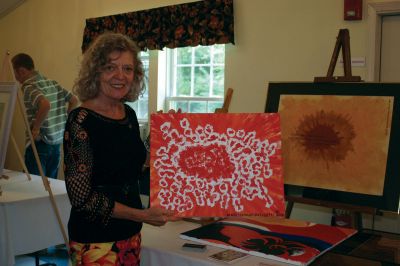 Art Show
Water-based mixed media artist Renee Richard Ouellette poses with one of her paintings at the inaugural Fine Arts Cafe fundraiser at the First Congregational Church of Rochester on September 25, 2010. Photo by Laura Peduli
