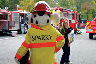 Fire Department Open House
Sue shannon (right) takes a photo of her daughter Ella (left) with Sparky the Fire Dog, official mascot of the Marion Fire Department, during the station's annual open house, celebrating the start of national Fire Prevention Awareness week on October 7, 2012.  Photo by Eric Tripoli.  
