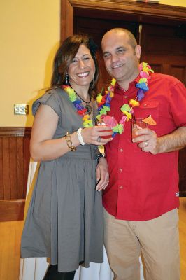 Fireworks Gala
People were still trickling in at 8:00 pm as the Marion Fireworks Committee’s second annual beach party on April 5 started picking up the pace with music and lights provided by Fun 107’s Michael Rock, and guests holding drinks with little umbrellas began shaking their hips. There was the scent of tropical coconutty sunblock in the air as guests perused the items up for auction, including a luxury African photo safari valued at $5,500. Photo by Jean Perry
