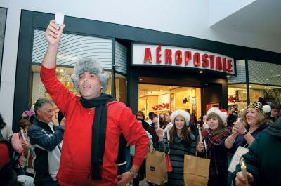 Flash Mob
Mattapoisett native and Old Rochester Regional graduate Chad Michael Peters coordinated a "flash mob" on December 16. The mob of over 200 carolers, including many Tri-Town residents, convened at the Dartmouth Mall to surprise shoppers with a medley of three holiday classics: "Deck the Halls", "Silent Night" and "Jingle Bells". Just as soon as the mob showed up, it dispersed. Photo by Felix Perez.
