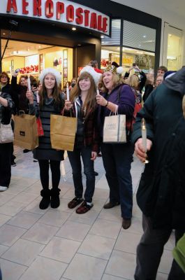 Flash Mob
Mattapoisett native and Old Rochester Regional graduate Chad Michael Peters coordinated a "flash mob" on December 16. The mob of over 200 carolers, including many Tri-Town residents, convened at the Dartmouth Mall to surprise shoppers with a medley of three holiday classics: "Deck the Halls", "Silent Night" and "Jingle Bells". Just as soon as the mob showed up, it dispersed. Photo by Felix Perez.
