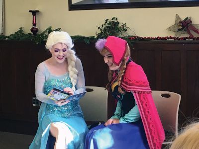 Frozen Princesses
On December 21, two princesses visited the Mattapoisett Public Library to read stories and sing songs from the Disney film Frozen. Princesses Elsa and Anna beguiled the children as well as their parents in an hour-long performance culminating in hugs and a photo session. The delightful event was sponsored by the Friends of the Mattapoisett Library. Photos by Marilou Newell
