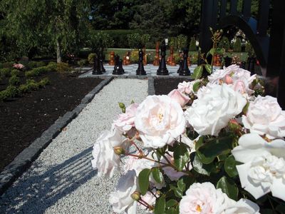 Gardens by the Sea
 This larger than life-sized chessboard surrounded by roses is just one of the unique gardens featured in St. Gabriel’s Church and the Garden Club of Marion’s garden tour titled, “Gardens by the Sea” on Friday, July 11th. This garden belonging to one Garden Club member was inspired by J.K. Rowling’s Harry Potter series. Photo by Jacqueline Hatch. 
