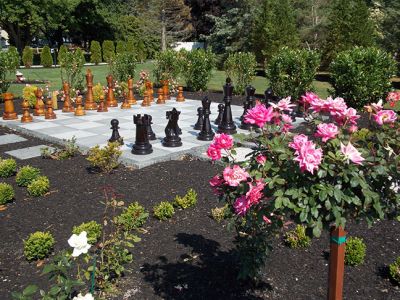 Gardens by the Sea
 This larger than life-sized chessboard surrounded by roses is just one of the unique gardens featured in St. Gabriel’s Church and the Garden Club of Marion’s garden tour titled, “Gardens by the Sea” on Friday, July 11th. This garden belonging to one Garden Club member was inspired by J.K. Rowling’s Harry Potter series. Photo by Jacqueline Hatch. 
