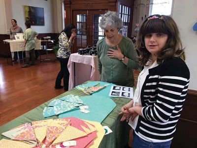 Grace Costa-Medeiros
Grace Costa-Medeiros, 19, of Marion, sells her hand-sewn napkins and tablecloths at a craft fair in Fairhaven on Saturday, April 23, with her support worker from the Nemaskett Group. Costa-Medeiros is an ORR student who will participate in the regional school district’s first age 18-22 community-based instruction program, a special education program that teaches life skills and provides support for community involvement. Photo by Pat Charyk
