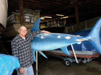 Big Fish
Manuel Perry poses with the Swordfish Weathervane which he helps maintain for display each year on the town Wharf. Photo by Joan Hartnett-Barry
