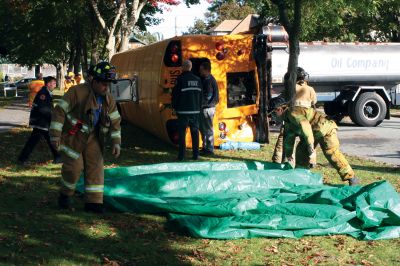 Disaster Drill
Fairhaven Fire Department hosted a full-scale exercise to improve emergency response in the region. Mattapoisett, Rochester, Dartmouth, Freetown, Acushnet, and New Bedford all responded to a disaster that simulated an accident between a school bus and an oil truck at Livesey Park in Fairhaven. Twenty drama students from New Bedford Vocational High School played the part of injured students who were assessed and treated for injuries. Photo by Anne OBrien-Kakley.
