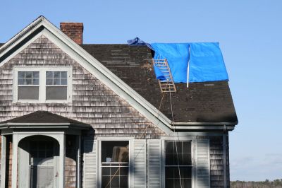 Historic Fire
A blue tarp hides the extensive roof damage the antique house on Delano Road suffered in the December 4, 2009 fire. The fire, which started in the rear right section of the house, licked up the side of the house and left a hole in the roof.
