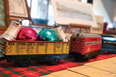 Holiday Tour
The Mattapoisett Historical Society and Carriage House opened its doors for the holiday season on Saturday, November 24.  The Historical Society is having its annual holiday shop, which features a variety of unique gifts such as historical postcard and map recreations, books, and tree ornaments.  Kids will get a kick out of the Lionel model train that zooms past a village of illuminated porcelain buildings. Photos by Eric Tripoli.  
