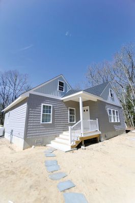 Habitat for Humanity Home
Christine and Josh Liggerio stand with their daughter Hailey, 9, and son Keagan, 6, on the porch of their new Habitat for Humanity home in Marion on March 19. The Liggerios celebrated the completion of their new Wareham Road home with Habitat for Humanity of Buzzard’s Bay executives, Representative Bill Straus, and a crowd of well-wishers during a dedication ceremony on Saturday. Photo by Felix Perez
