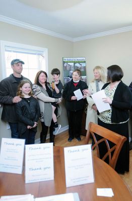 Habitat for Humanity Home
Christine and Josh Liggerio stand with their daughter Hailey, 9, and son Keagan, 6, on the porch of their new Habitat for Humanity home in Marion on March 19. The Liggerios celebrated the completion of their new Wareham Road home with Habitat for Humanity of Buzzard’s Bay executives, Representative Bill Straus, and a crowd of well-wishers during a dedication ceremony on Saturday. Photo by Felix Perez
