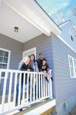 Habitat for Humanity Home
Christine and Josh Liggerio stand with their daughter Hailey, 9, and son Keagan, 6, on the porch of their new Habitat for Humanity home in Marion on March 19. The Liggerios celebrated the completion of their new Wareham Road home with Habitat for Humanity of Buzzard’s Bay executives, Representative Bill Straus, and a crowd of well-wishers during a dedication ceremony on Saturday. Photo by Felix Perez
