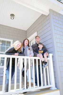 Habitat for Humanity Home
Christine and Josh Liggerio stand with their daughter Hailey, 9, and son Keagan, 6, on the porch of their new Habitat for Humanity home in Marion on March 19. The Liggerios celebrated the completion of their new Wareham Road home with Habitat for Humanity of Buzzard’s Bay executives, Representative Bill Straus, and a crowd of well-wishers during a dedication ceremony on Saturday. Photo by Felix Perez
