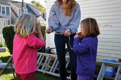 Autumn Celebration
Sisters Amalia (left) and Eden (right) Dupres share an apple peel at the Mattapoisett Historical Society fall celebration on Saturday, Ocotober 13, 2012.  Photo by Eric Tripoli.  
