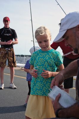 Fish Story
The Buzzards Bay Anglers Club hosted the First Annual Gus Casassa Scup Cup fishing tournament at the Mattapoisett Wharves on Saturday, July 11. The event attracted about 20 youngsters aged twelve and younger with each child receiving a new fishing rod and reel as part of their entry. Winners, who caught the largest fish of the day, also were awarded plaques for their efforts. Photo by Robert Chiarito.
