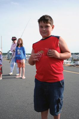 Fish Story
The Buzzards Bay Anglers Club hosted the First Annual Gus Casassa Scup Cup fishing tournament at the Mattapoisett Wharves on Saturday, July 11. The event attracted about 20 youngsters aged twelve and younger with each child receiving a new fishing rod and reel as part of their entry. Winners, who caught the largest fish of the day, also were awarded plaques for their efforts. Photo by Robert Chiarito.
