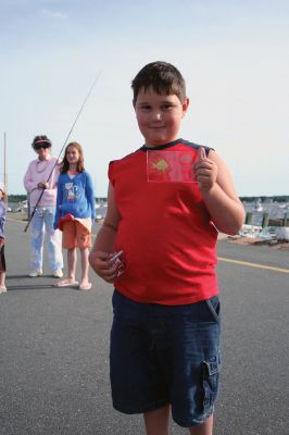 Fish Story
The Buzzards Bay Anglers Club hosted the First Annual Gus Casassa Scup Cup fishing tournament at the Mattapoisett Wharves on Saturday, July 11. The event attracted about 20 youngsters aged twelve and younger with each child receiving a new fishing rod and reel as part of their entry. Winners, who caught the largest fish of the day, also were awarded plaques for their efforts. Photo by Robert Chiarito.
