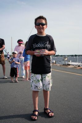 Fish Story
The Buzzards Bay Anglers Club hosted the First Annual Gus Casassa Scup Cup fishing tournament at the Mattapoisett Wharves on Saturday, July 11. The event attracted about 20 youngsters aged twelve and younger with each child receiving a new fishing rod and reel as part of their entry. Winners, who caught the largest fish of the day, also were awarded plaques for their efforts. Photo by Robert Chiarito.
