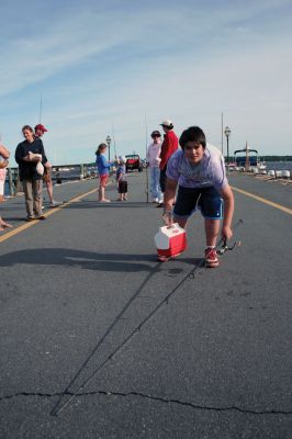 Fish Story
The Buzzards Bay Anglers Club hosted the First Annual Gus Casassa Scup Cup fishing tournament at the Mattapoisett Wharves on Saturday, July 11. The event attracted about 20 youngsters aged twelve and younger with each child receiving a new fishing rod and reel as part of their entry. Winners, who caught the largest fish of the day, also were awarded plaques for their efforts. Photo by Robert Chiarito.
