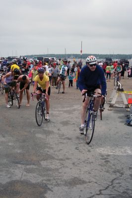 Triathlon 2009
Over two hundred athletes participated in this year's Mattapoisett Triathlon on Sunday morning, July 12. The athletes endurance was tested over a course which included a quarter-mile swim, a ten-mile bike ride and a three and three quarters-mile run. The race marks the beginning of the Mattapoisett Lions Club's annual Harbor Days Celebration with events including a craft fair, several suppers and a pancake breakfast , which unfold over the course of the week. Photo by Robert Chiarito.
