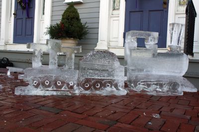 Ice Sculpture at the Marion Art Center
In front of the Marion Art Center, Tim Wade carved out an ice sculpture of a train on December 13, an unseasonably warm December day. The MAC reported several phone calls concerning the heat and whether the event would be canceled. Wade made his icy creation despite the warmth, as he has done for 10 years. Photos by Jean Perry
