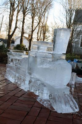 Ice Sculpture at the Marion Art Center
In front of the Marion Art Center, Tim Wade carved out an ice sculpture of a train on December 13, an unseasonably warm December day. The MAC reported several phone calls concerning the heat and whether the event would be canceled. Wade made his icy creation despite the warmth, as he has done for 10 years. Photos by Jean Perry
