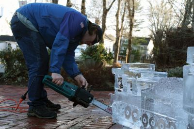 Ice Sculpture at the Marion Art Center
In front of the Marion Art Center, Tim Wade carved out an ice sculpture of a train on December 13, an unseasonably warm December day. The MAC reported several phone calls concerning the heat and whether the event would be canceled. Wade made his icy creation despite the warmth, as he has done for 10 years. Photos by Jean Perry
