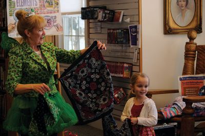 Irish Fairy Godmother
Bringing with her a magical teapot, the Irish Fairy Godmother visited the Joseph H. Plumb Memorial Library March 7, treating about 25 kids to a magic show. Magician Debbie O’Carroll said her favorite part about being the Irish Fairy Godmother is seeing the cheerful responses from her young audience. Photos by Felix Perez
