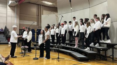 FORM
Music and vocals teacher Susan Audette leads the chorus from the Rochester Memorial School. Photo Courtesy Old Rochester Regional School District and MA Superintendency Union #55.
