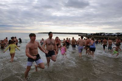 Keep on Plungin’ 
The annual Keep on Plungin’ New Year’s Day swim drew well over 100 participants to Mattapoisett Town Beach, continuing a tradition started in 2013 by Will and Michelle Huggins to help families facing expenses related to cancer care. In the last two years, the community-driven effort has benefitted three families and Dana Farber with a $1,000 donation in Huggins’ honor. This year, organizers anticipate supporting at least two more families with checks for $2,000. Photos by Mick Colageo
