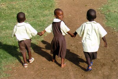 Kenya Relief
Three Kenyan orphans  including Grace, center  enjoy their new shoes. These were just some of the children that Mattapoisett residents Greg and Marina Wurl met on their recent medical mission trip to Migori, Kenya. Photo courtesy of the Wurl family.
