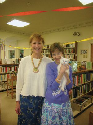 Judy Kleven Retires
Scores of admirers gathered on Friday to celebrate the service of Head Librarian Judy Kleven, who retired after 27 years at Elizabeth Taber. Young Max Richins presented Kleven with an Eiffel Tower-themed card, as she hopes to travel to Paris in retirement, while others brought a book-shaped cake and a new cat – Noah. Photos by Joan Hartnett-Barry
