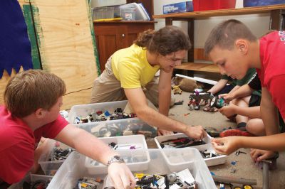 LEGO Robotics 
(clockwise from left) Worcester Polytechnical Institute students Daniel Miller and Sidney Batchelder (center) volunteered to help run the Marion Natural History Museum's summer LEGO Robotics program. Nathan Perry (right) searches for just the right piece for his creation.  Photo by Eric Tripoli. 
