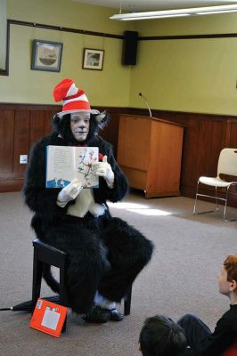 Mattapoisett Free Library Birthday
“Say Triskaidekaphobia!” the Cat in the Hat told the children, posing for a photo at the Mattapoisett Free Library on Saturday, March 22. What the heck is that, the children asked the Cat in the Hat. “Google it!” he told the children laughing at his silliness. The library knows how to throw a party, celebrating five years since the Friends of the Mattapoisett Library funded the expansion of the library. “They even bought a cake,” said Children’s Services Librarian Sandra Burke.  By Jean Perry
