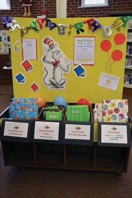 Mattapoisett Free Library Birthday
“Say Triskaidekaphobia!” the Cat in the Hat told the children, posing for a photo at the Mattapoisett Free Library on Saturday, March 22. What the heck is that, the children asked the Cat in the Hat. “Google it!” he told the children laughing at his silliness. The library knows how to throw a party, celebrating five years since the Friends of the Mattapoisett Library funded the expansion of the library. “They even bought a cake,” said Children’s Services Librarian Sandra Burke.  By Jean Perry
