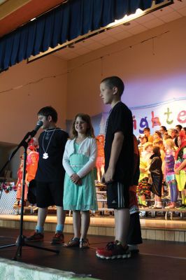 Lighten Up
Third-graders on June 16 performed their play “Lighten Up,” donning rainbow wigs, gigantic glasses, tutus, and brightly colored mustaches to remind everyone to not take themselves so seriously all the time. The students sang silly songs, told jokes, and offered some valuable advice like, “When life makes you sweat, wear deodorant!” By Jean Perry
