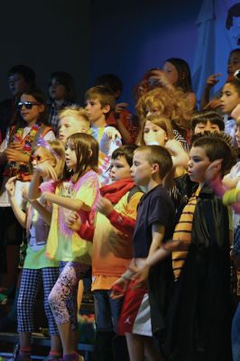 Lighten Up
Third-graders on June 16 performed their play “Lighten Up,” donning rainbow wigs, gigantic glasses, tutus, and brightly colored mustaches to remind everyone to not take themselves so seriously all the time. The students sang silly songs, told jokes, and offered some valuable advice like, “When life makes you sweat, wear deodorant!” By Jean Perry
