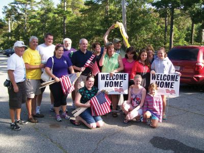 Welcome Home
The Mattapoisett Lions were among locals who banded together last week to give a proper welcome home to Marine Corps Lance Corporal Greg Rosperich and Army Sergeant Ryan McGrath. From left to right: KL Joe Murray, IPKL Don Bamberger, Peter Hodges (with his granddaughter), and Ron Ellis join Kim Corazinni at her Route 6 flag and ribbon decorating party. Photo courtesy of Mattapoisett Lions President Joe Murray.
