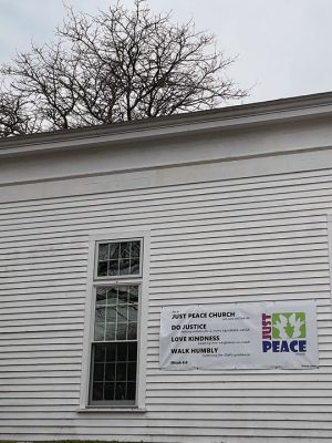 Mattapoisett Congregational Church 
Mattapoisett Congregational Church displays a banner announcing its status as a Just Peace church. Drew, and Lynne Nahigyan work with an entire committee of church members and community members focused on education, justice, climate and many other social issues. Photo courtesy of Jennifer F. Shepley
