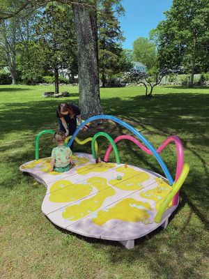 On view now as an outdoor art installation are two works created by UMass visual art students located at Dunseith, the Mattapoisett Land Trust park property at the corner of Route 6 and North Street. Both works are interactive in that The Bean has moveable parts that give viewers of all ages the opportunity to leave their own impact on tiny sculptures by relocating them across the surface of the sculpture. The Catalyst is bed-like, beckoning viewers to set aside cares and rest for a moment. 
