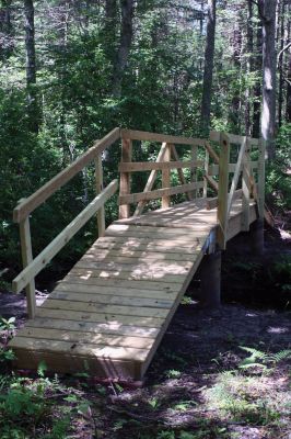 MLT Bridge
Mattapoisett residents Geoff King and Paul Osenkowski, along with Luke Buckley and Alex Buckley installed the footbridge over a stream on a Mattapoisett Land Trust trail on July 3, 2010. Photo by Andrea Buckley.
