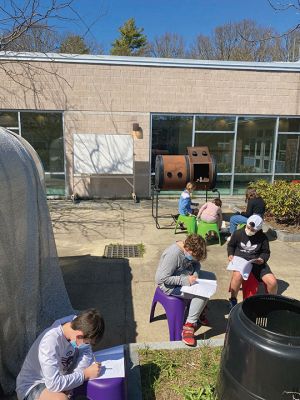 Classroom Donation
The Mattapoisett Land Trust donated equipment to outfit an Outdoor Classroom, including a whiteboard and 24 colorful stools delivered to Old Hammondtown School by the Education Committee. Grade 5 students are working with Ben Squire, ORR District science coordinator, on an ongoing science compost project that analyzes the conditions needed for composting. The students have five pumpkins in different locations since last October and were looking at them for the first time last week. Photos by Ellen Flynn
