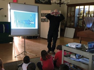 Marion Natural History Museum
On Valentines Day, the Marion Natural History Museum's afterschool group had a chance to learn about humpback and right whales. Dr. Moore of the Woods Hole Oceanographic Institution showed the students how a drone may be used to observe a whale's spout to determine its health. We also had a chance to view bubble-netting practices of humpbacks, see how baleen plates fit in a whale's mouth, and discussed the hazards the whales face due to entanglements in fishing gear. Photo courtesy Elizabeth Leidhold
