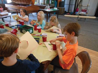 Marion Natural History Museum’s “Composting”
Investigating what makes a healthy soil during the Marion Natural History Museum’s “Composting” afterschool program.  The students took a look at some of the animals that help to break down compost and built a mini-composter to bring home. Photo courtesy Elizabeth Leidhold
