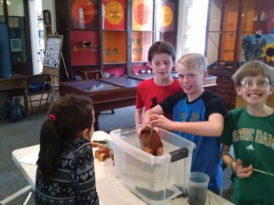 Marion Natural History Museum
The Marion Natural History Museum welcomed a visit from Mark Whelan, engineer with Sippican/Lockheed Martin Corp.  Mark allowed us to experiment with compression, stability and buoyancy. We built our own submarines and figured out how to make it sink, but not too fast. Then we held a race to see whose submarine sank the slowest. The group had a great time working with all the materials and we’d like to thank Mark and Sippican/Lockheed Martin for the wonderful program. 
