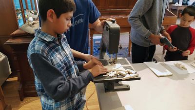 Marion Natural History Museum
The Marion Natural History Museum after school group had a wonderful time exploring what works (and what doesn't) when constructing a wooden sailboat. The students constructed their own boat, either a single hull or catamaran, and added a sail and keel. After decorating their vessels, students raced the boats down two long rain gutters filled with water. Many thanks to engineer Mark Whalen for yet another terrific program! Photos courtesy Elizabeth Leidhold
