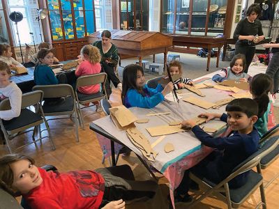 Marion Museum of Natural History
The Marion Museum of Natural History would like to thank Karen Alves Cronin and our volunteer parents for the wonderful program March 15. First, Karen showed us how gravity and a simple bucket suspended on a line and filled with paint can produce beautiful paintings. The students painted their canvases with a colorful background and then placed them under the suspended bucket pendulum. When filled with paint and rotated over the canvases.
