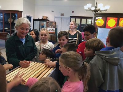 Marion Natural History Museum
The Marion Natural History Museum wishes to thank Kitty Degroot for sharing her expertise as a beekeeper with our group. The students learned that 10 bees weigh the same as one M&M, and how bees communicate by dancing. We explored beekeeping equipment and which hive box holds the queen and which holds the honey. The museum also wishes to thank the volunteers who assisted with the program. Photo courtesy Elizabeth Leidhold
