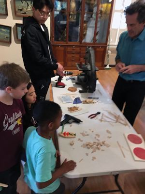 Marion Natural History Museum
One hull or two? On March 11, the Marion Natural History Museum afterschool group explored the physics behind sailboat design. Mark Whalen, engineer with Massachusetts Maritime Academy, introduced several alternative design ideas for constructing our own sailboats. The students explored a variety of hull designs, mast locations and different sizes and shapes of sails. Then they raced the vessels in rain gutters to see which design moved fastest.
